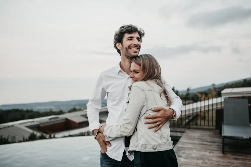 A happy couple laughing together outdoors